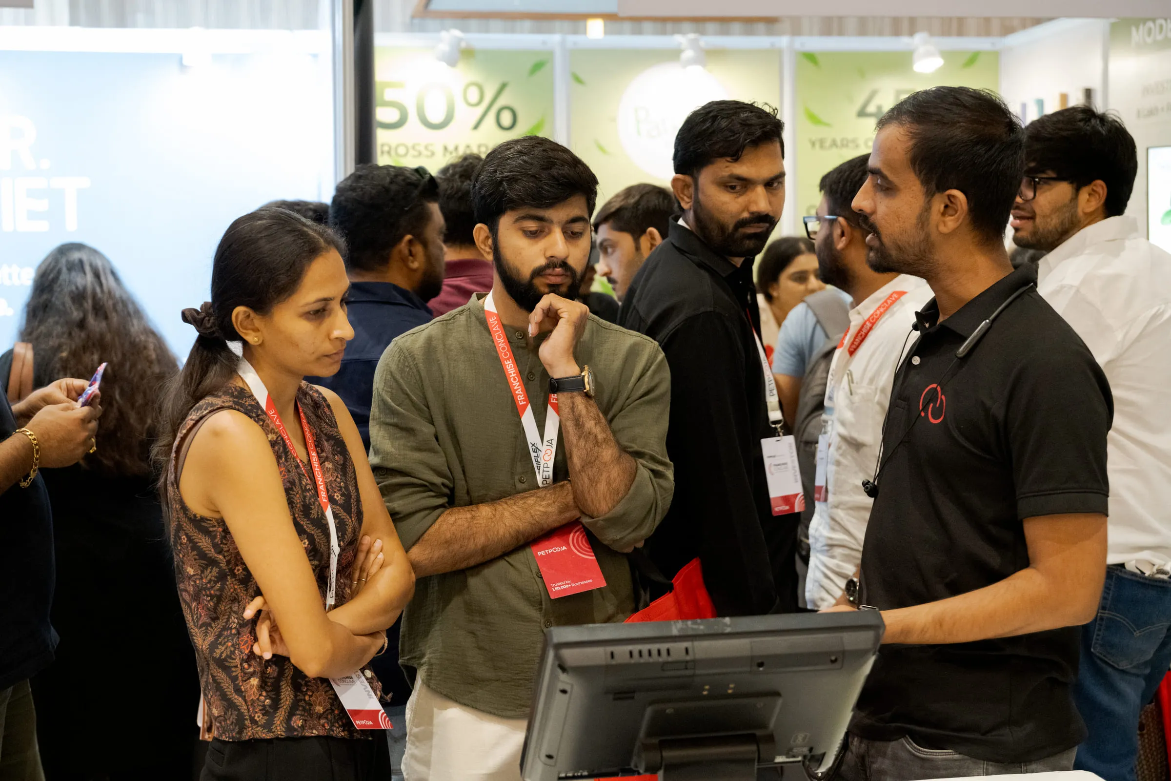 Visitors watching a Petpooja point-of-sale demonstration